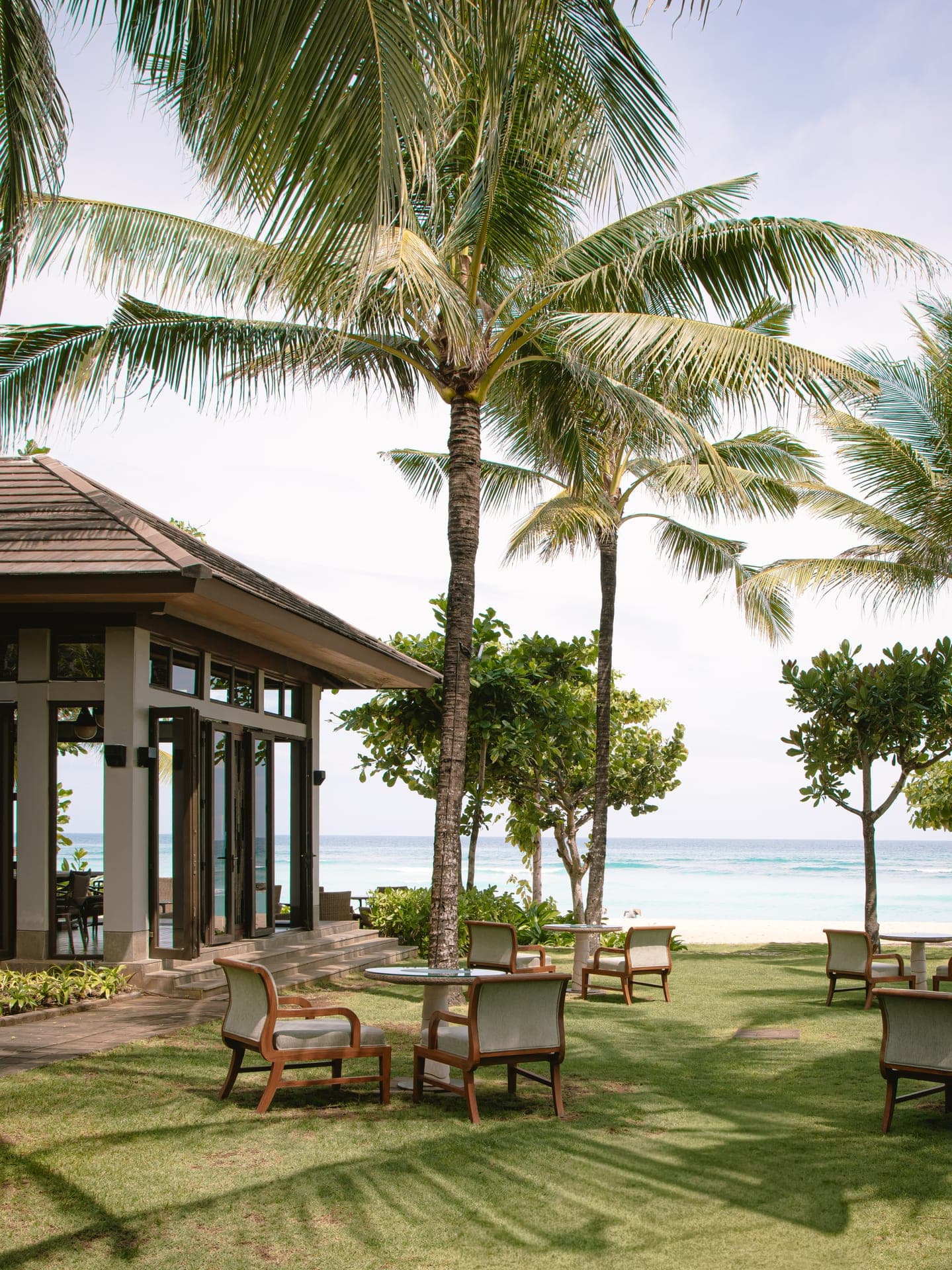 Beachfront lawn and palms at The Ritz-Carlton Bali