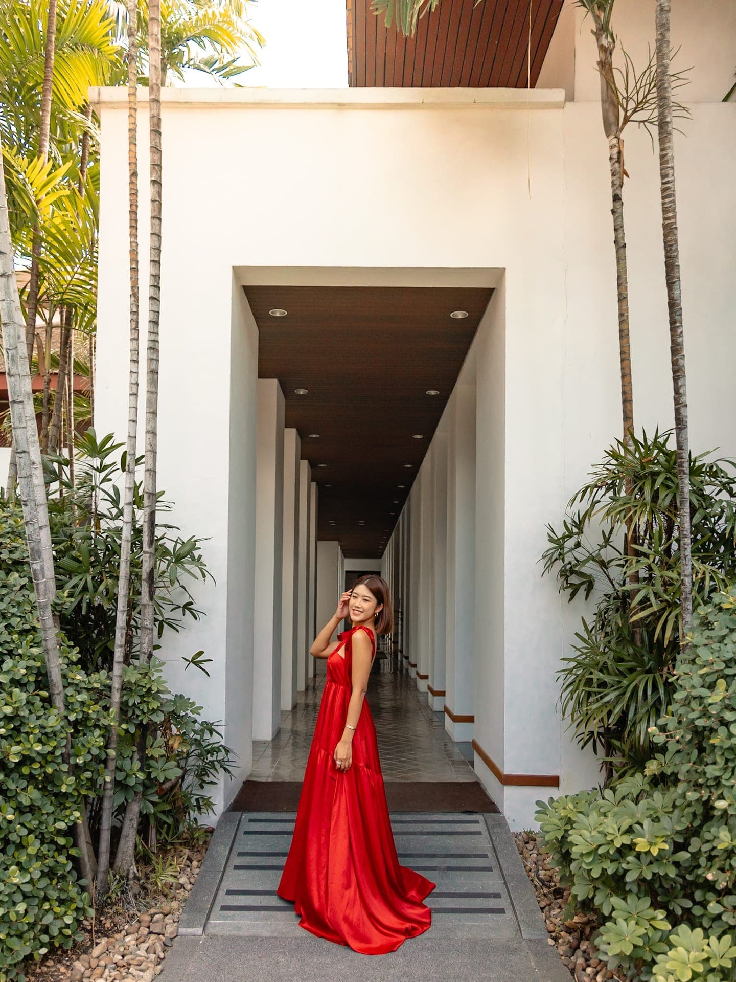 Short-form story frame in a sculptural courtyard corridor in Bangkok
